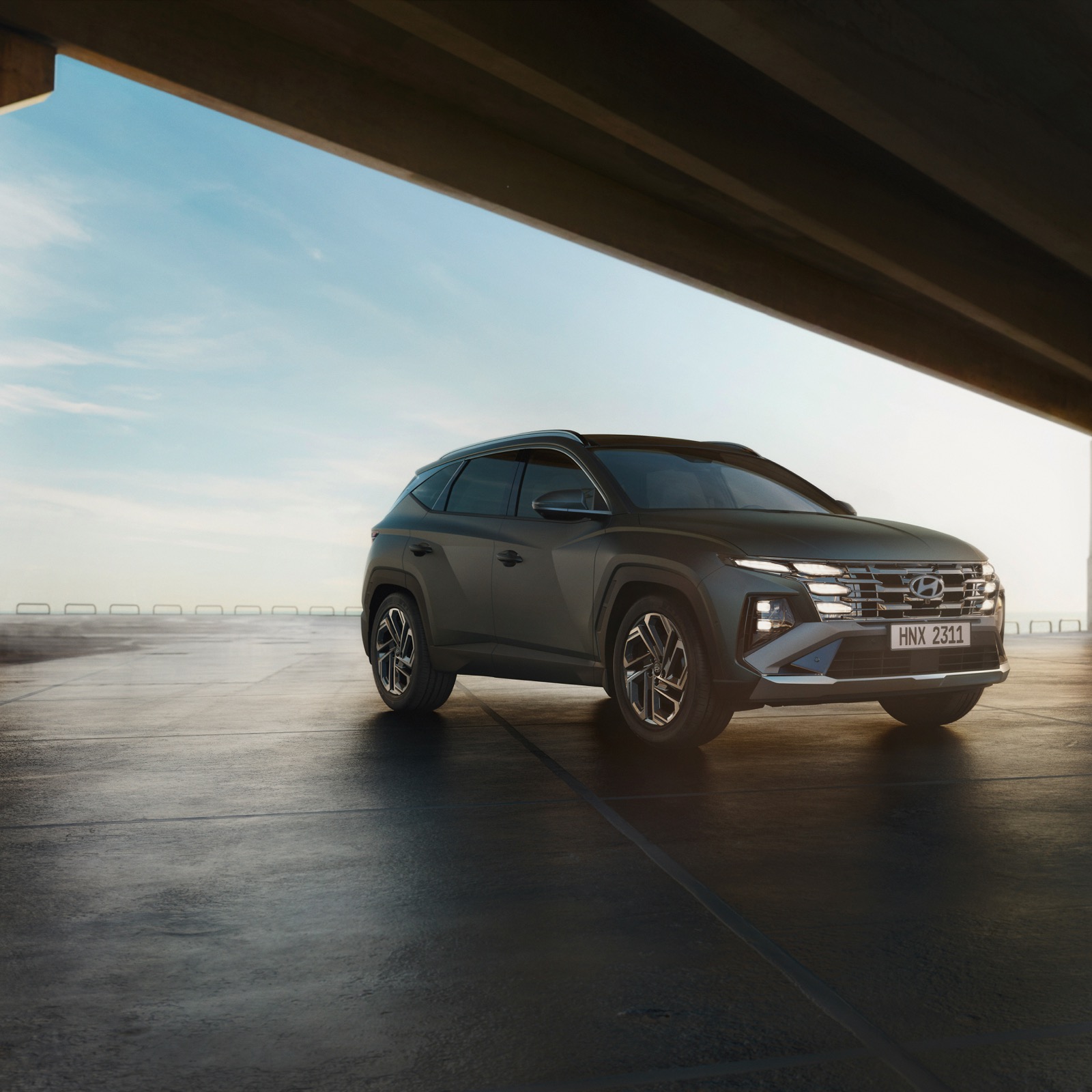 Hyundai Tucson under dramatic architectural lighting