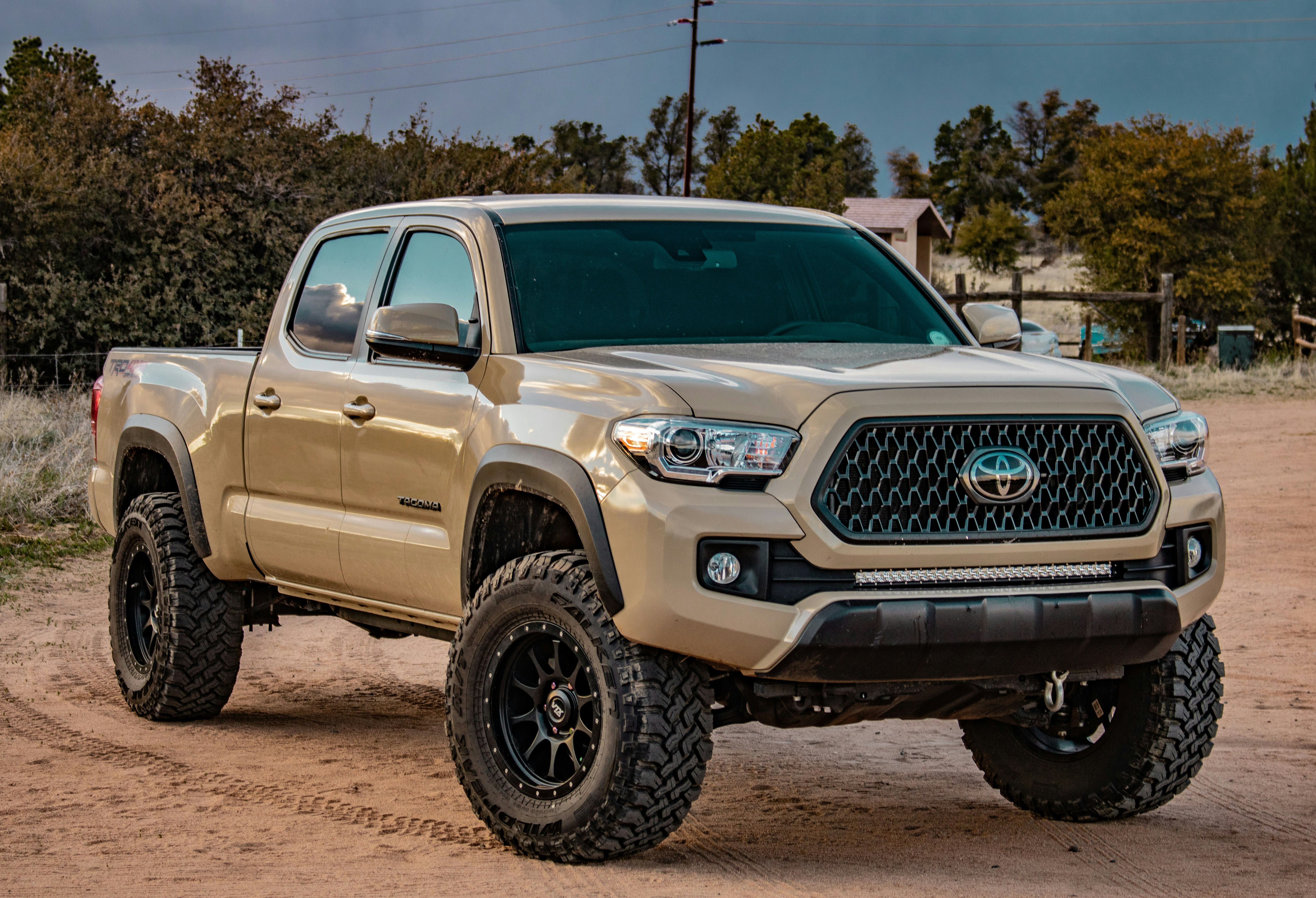Toyota Tacoma TRD driving on a dirt trail in rugged terrain